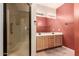 Bathroom with a double sink vanity, framed mirror, and glass-enclosed shower at 7101 W Beardsley Rd # 1403, Glendale, AZ 85308