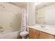 Well-lit bathroom with a shower-tub combo and vanity with wood-look cabinets at 7101 W Beardsley Rd # 1403, Glendale, AZ 85308