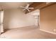 Empty bedroom featuring a high ceiling, ceiling fan and large carpeted floorspace at 7101 W Beardsley Rd # 1403, Glendale, AZ 85308
