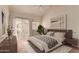 Serene primary bedroom with large bed, modern decor, and access to a private patio at 7101 W Beardsley Rd # 1403, Glendale, AZ 85308
