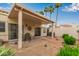 Charming covered patio with seating area, gravel landscaping, and palm tree accents at 7101 W Beardsley Rd # 1403, Glendale, AZ 85308