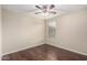 Bedroom features ceiling fan, window, and wood floors at 7516 S 31St Pl, Phoenix, AZ 85042