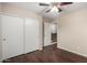 Bedroom features wood floors, sliding door closet, and doorway to hallway at 7516 S 31St Pl, Phoenix, AZ 85042