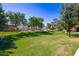 Beautiful community park with mature trees, lush green grass, and open space for recreation and relaxation at 7516 S 31St Pl, Phoenix, AZ 85042