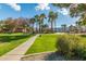 Community park showcasing a sidewalk, playground, palms, grass, and desert trees at 7516 S 31St Pl, Phoenix, AZ 85042