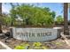 Hunter Ridge community sign in a landscaped area, showcasing trees and greenery at 7516 S 31St Pl, Phoenix, AZ 85042