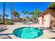 Inviting hot tub surrounded by lush landscaping, palm trees, and lounge chairs offering a relaxing oasis for residents at 7516 S 31St Pl, Phoenix, AZ 85042