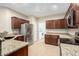 Well-lit kitchen featuring stainless steel appliances and granite countertops at 7516 S 31St Pl, Phoenix, AZ 85042