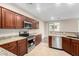 Bright kitchen with stainless steel appliances, granite countertops and tile floors at 7516 S 31St Pl, Phoenix, AZ 85042
