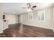 Bright living room with hardwood floors, a ceiling fan, and large windows at 7516 S 31St Pl, Phoenix, AZ 85042