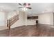 Open-concept living room with hardwood floors and a staircase at 7516 S 31St Pl, Phoenix, AZ 85042