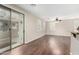 Open-plan living area with sliding glass doors and hardwood floors at 7516 S 31St Pl, Phoenix, AZ 85042