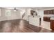 Living room with hardwood floors and granite kitchen counter with adjacent stairs at 7516 S 31St Pl, Phoenix, AZ 85042