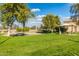 Neighborhood park showcasing green grass, shade trees, ramada, benches, and a volleyball court at 7516 S 31St Pl, Phoenix, AZ 85042