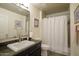Bathroom featuring granite countertops, a single sink, and a shower with a tub at 7601 E Indian Bend Rd # 1050, Scottsdale, AZ 85250