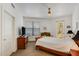 Bright bedroom with a dresser, ceiling fan, and access to the balcony at 7601 E Indian Bend Rd # 1050, Scottsdale, AZ 85250