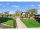 Serene park and picnic area with lush green grass and mature trees under a bright blue sky at 7601 E Indian Bend Rd # 1050, Scottsdale, AZ 85250