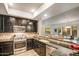 Modern kitchen featuring stainless steel appliances, granite countertops, and dark wood cabinetry at 7601 E Indian Bend Rd # 1050, Scottsdale, AZ 85250
