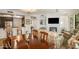 Open-concept living room and dining area with a fireplace, television, and comfortable seating at 7601 E Indian Bend Rd # 1050, Scottsdale, AZ 85250