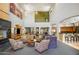 Bright lounge area with soaring ceilings and large windows, fireplace, and multiple seating options at 7601 E Indian Bend Rd # 1050, Scottsdale, AZ 85250