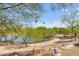 Scenic walking path winding through a lush green desert landscape by a lake at 7601 E Indian Bend Rd # 1050, Scottsdale, AZ 85250