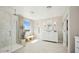 Modern bathroom featuring a glass shower, shaker cabinets, and a bench near a window with scenic views at 8047 W Griswold Rd, Peoria, AZ 85345