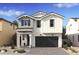 Charming two-story home with a modern farmhouse design and a well-manicured front yard at 8047 W Griswold Rd, Peoria, AZ 85345