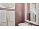 Elegant powder room with a pedestal sink, decorative mirror, and soft lighting at 8047 W Griswold Rd, Peoria, AZ 85345