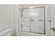 Bathroom featuring a tub/shower combo with a sliding glass door and shower head at 9450 N 94Th Pl # 214, Scottsdale, AZ 85258