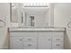 Bright bathroom vanity area with double sinks, granite counters, ample storage, and a large mirror at 9450 N 94Th Pl # 214, Scottsdale, AZ 85258