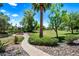Well-maintained community grounds with lush landscaping, mature trees, and paved pathways at 9450 N 94Th Pl # 214, Scottsdale, AZ 85258