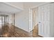Bright hallway with hardwood floors and white doors leading to various rooms at 9450 N 94Th Pl # 214, Scottsdale, AZ 85258