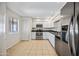Well-lit kitchen featuring stainless steel appliances and white cabinetry at 9450 N 94Th Pl # 214, Scottsdale, AZ 85258