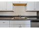 Bright kitchen featuring a stainless steel sink, white cabinets, and dark countertop at 9450 N 94Th Pl # 214, Scottsdale, AZ 85258