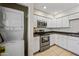 Cozy kitchen featuring modern appliances, tile floors, and washer and dryer in closet at 9450 N 94Th Pl # 214, Scottsdale, AZ 85258