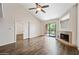 Open living room with hardwood floors, vaulted ceiling, and a corner fireplace at 9450 N 94Th Pl # 214, Scottsdale, AZ 85258