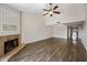 Open living room featuring a fireplace, ceiling fan, and hardwood floors at 9450 N 94Th Pl # 214, Scottsdale, AZ 85258