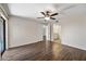 Spacious main bedroom featuring wood flooring, a ceiling fan, ensuite bath access, and plenty of natural light at 9450 N 94Th Pl # 214, Scottsdale, AZ 85258
