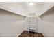 A clean and functional walk-in closet with built-in shelving and wood-look flooring at 9450 N 94Th Pl # 214, Scottsdale, AZ 85258