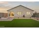 Backyard showcasing a brick paver patio, fire pit, artificial turf, and privacy fence at 10035 S Palo Verde Dr, Apache Junction, AZ 85120