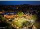 Aerial view of a luxurious estate featuring a putting green, pool, lush landscaping, and mountain views at 10092 E Troon North Dr, Scottsdale, AZ 85262