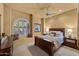 Inviting bedroom featuring a window seat, ceiling fan, and warm lighting, creating a cozy atmosphere at 10092 E Troon North Dr, Scottsdale, AZ 85262