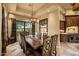 Dining room with large wood table, Southwest decor, stone floors and windows to the desert at 10092 E Troon North Dr, Scottsdale, AZ 85262