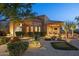 Home with well-manicured desert landscaping, a putting green, and a covered patio at 10092 E Troon North Dr, Scottsdale, AZ 85262
