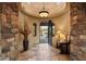 A grand foyer with travertine floors, stone accents and rotunda ceiling welcomes you into the home at 10092 E Troon North Dr, Scottsdale, AZ 85262
