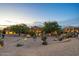 Professionally landscaped front yard with desert plants and trees surrounding the beautiful home at 10092 E Troon North Dr, Scottsdale, AZ 85262