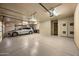 Garage featuring epoxy floors, a silver SUV, and two garage doors at 10092 E Troon North Dr, Scottsdale, AZ 85262