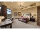 Large, open main bedroom featuring a dedicated desk and sitting area, complemented by an abundance of natural light at 10092 E Troon North Dr, Scottsdale, AZ 85262