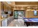 Entertainer's dream: game room with custom cabinetry, a wet bar and a walk out to an outdoor patio at 10092 E Troon North Dr, Scottsdale, AZ 85262