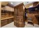 Custom walk-in closet with wood built-ins, shelving and drawers, designed for optimal organization at 10092 E Troon North Dr, Scottsdale, AZ 85262